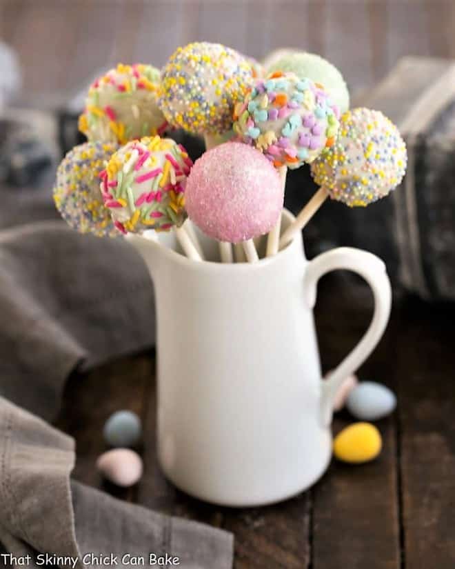 Easter Cake Pops displayed in a ceramic pitcher.
