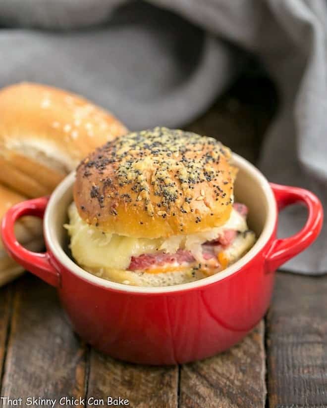 An individual Corned Beef Sliders in a red ceramic crock.