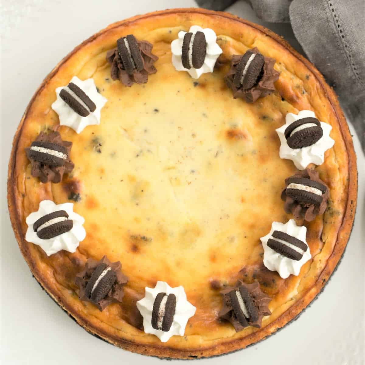 Overhead view of Oreo Cheesecake with Oreo Cookie Crust on a serving plate.