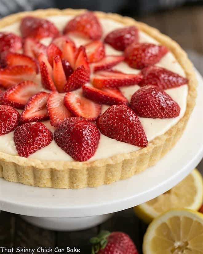 Strawberry Lemon Tart on a white cake stand.