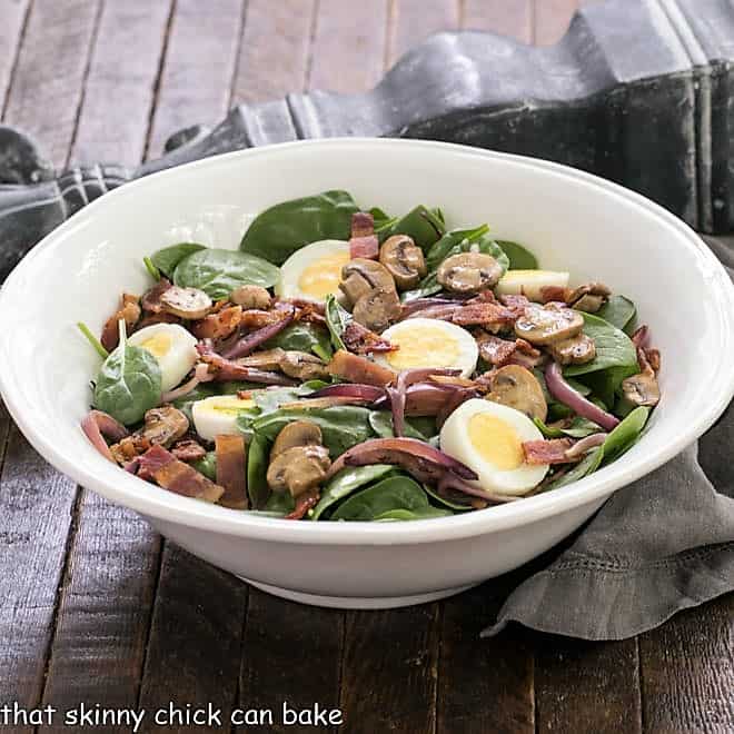 Best Spinach Salad in a white serving bowl