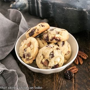 A white ceramic bowl filled with cherry chocolate chunk cookies