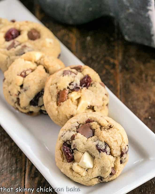 Chewy Cherry Chocolate Chunk Cookies on a narrow white tray