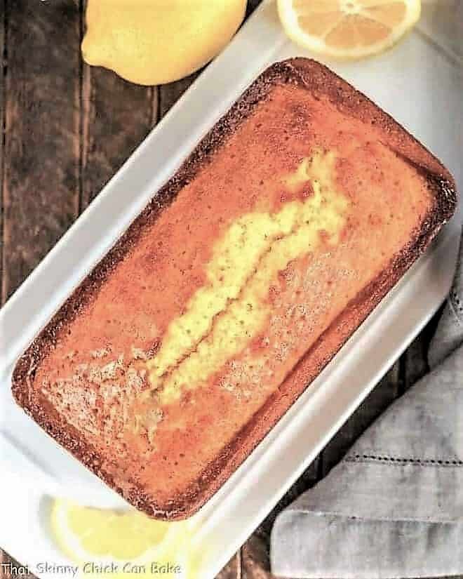 Glazed Lemon Cake Recipe overhead loaf view on a white tray.