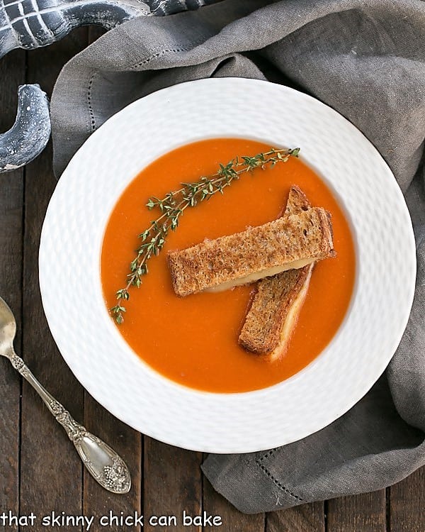 Thyme Kissed Tomato Soup in a white bowl overhead view.