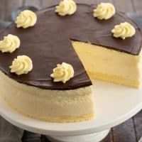 Boston Cream Pie Cheesecake with a slice removed.