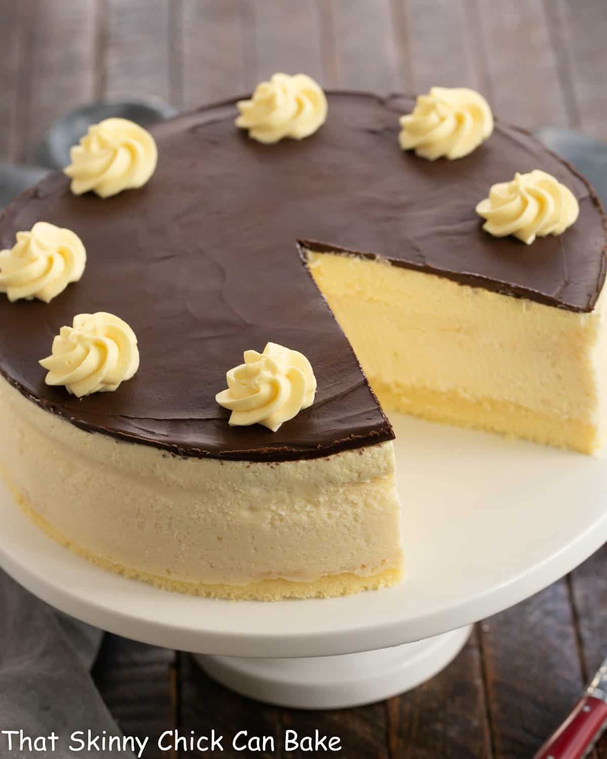 Boston Cream Pie Cheesecake with a slice removed.