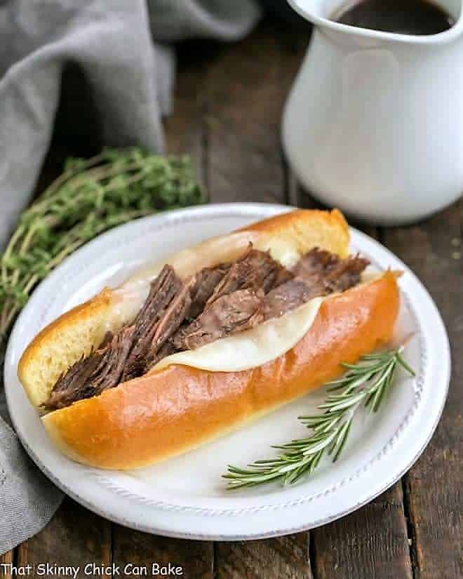 Instant Pot French Dip Sandwiches on a plate with au jus.