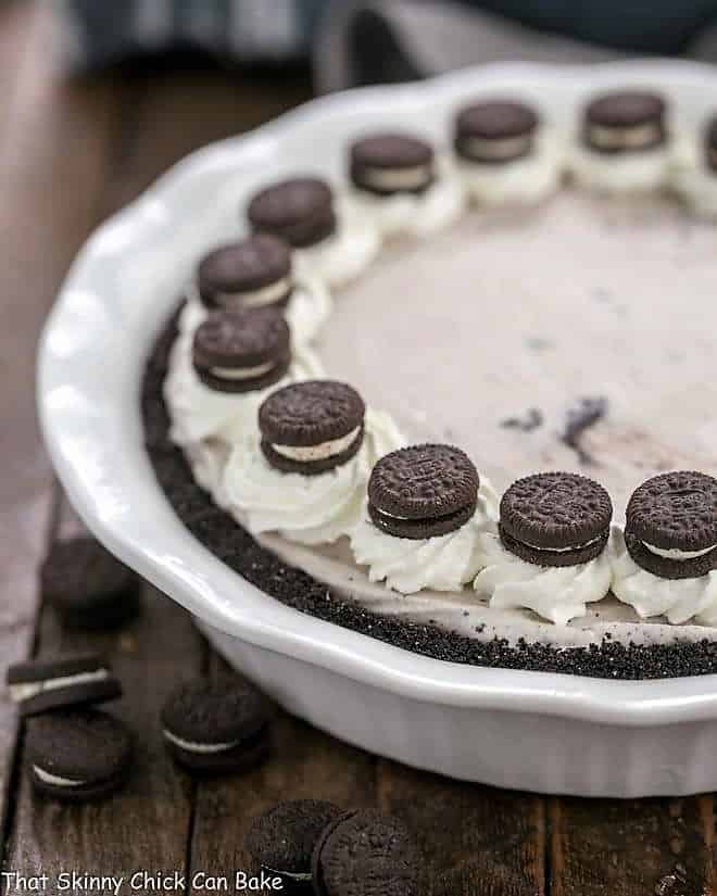 Layered Ice Cream Pie with Chocolate Cookie Crust in a white ceramic pie plate.