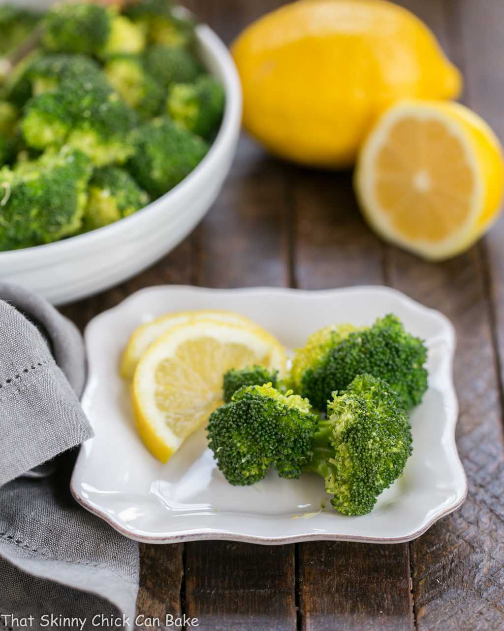 A plate of food with broccoli, with Garlic and Lemon.