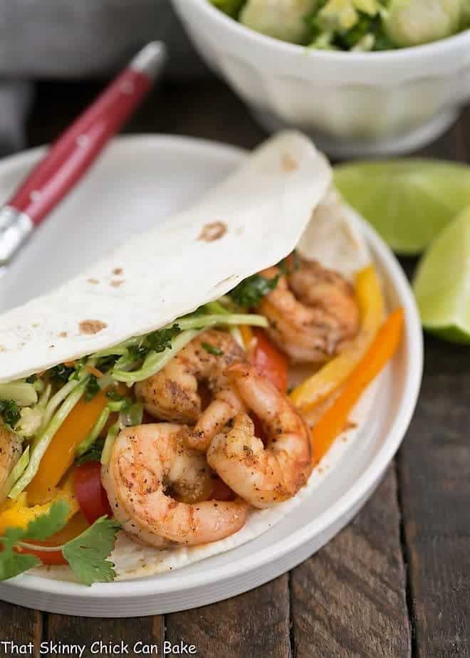 Spicy Shrimp Fajitas - an easy seafood recipe with a southwest flair Spicy Shrimp Fajitas on a white ceramic plate