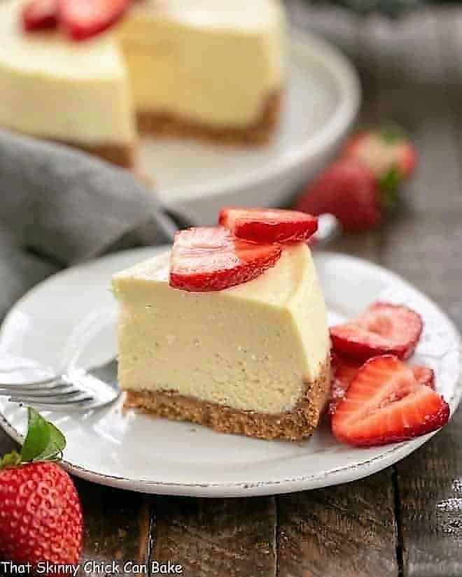 Slice of Vanilla Bean Instant Pot Cheesecake slice on a dessert plate.