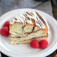 Cinnamon Twist Bread slice on a white plate with raspberries