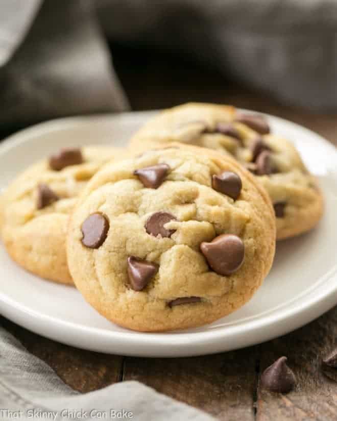 Double Chocolate Chip Cookies - chewy with milk and semisweet chocolate chips! Double Chocolate Chip Cookies on a small white plate