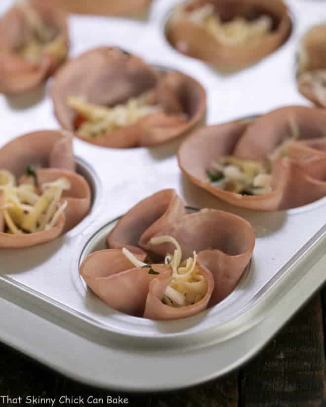 Egg Muffins in ham cups ready for the oven in a muffin tin