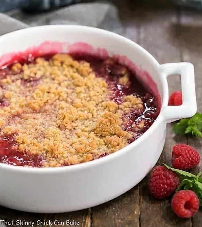 Fresh Raspberry Crisp in a round white casserole dish.