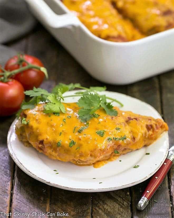 Easy Salsa Chicken on a small white plate with casserole in the background