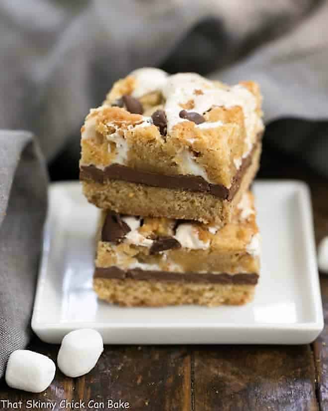 S'mores Cookie Bars stacked on a white plate.