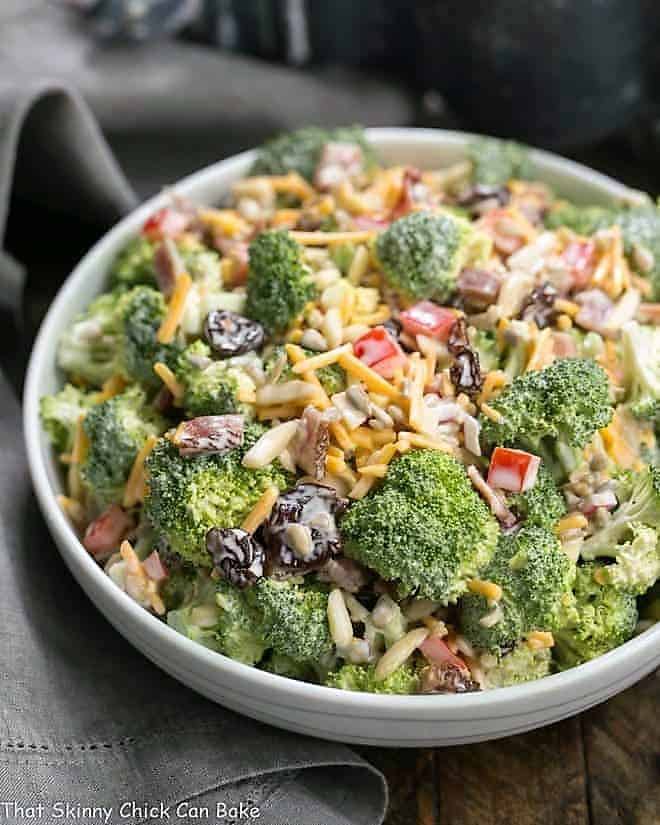 White ceramic bowl filled with Broccoli Salad with Bacon and Dried Cherries.