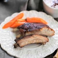 Instant Pot Baby Back Ribs on a white plate with carrots