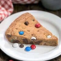 A wedge of Patriotic Skillet Cookie on a white enamel plate