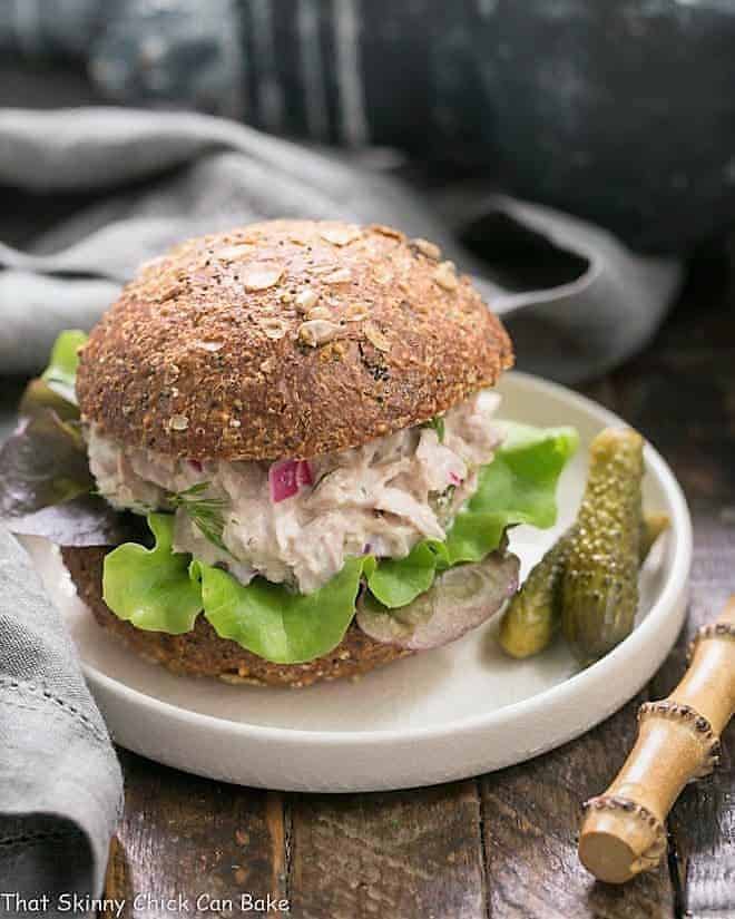 Easy Tuna Salad with Fresh Dill on a white plate with cornichons.