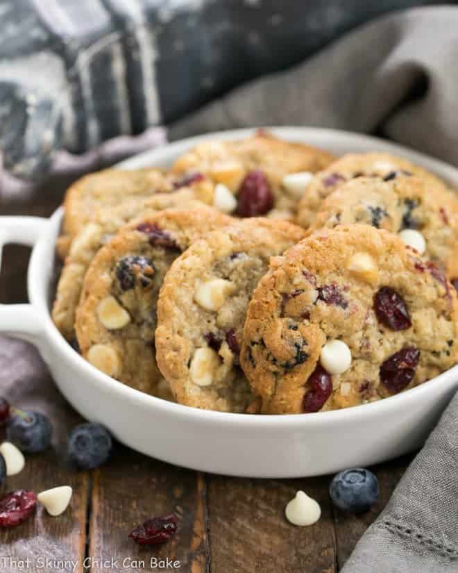 White Chocolate Chip Cookies with Dried Berries in a white ceramic terrine. 