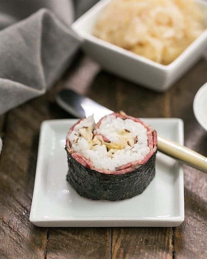 Beefshi - Reuben Roll on a small white square plate
