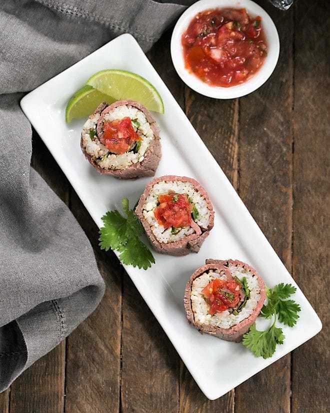 Beefshi - Beef Texan Rolls on a white rectangular tray topped with salsa