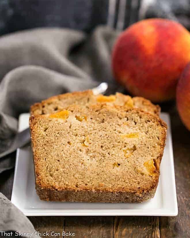 Fresh Southern Peach Bread slices on a square, white ceramic plate.