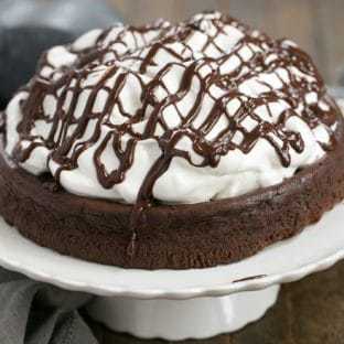 Flourless Chocolate Cake with Marshmallow Frosting - a dense dreamy chocolate cake topped with a mound of sweet, fluffy marshmallow frosting!