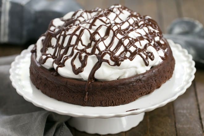 Flourless Chocolate Cake with Marshmallow Frosting - a dense dreamy chocolate cake topped with a mound of sweet, fluffy marshmallow frosting!