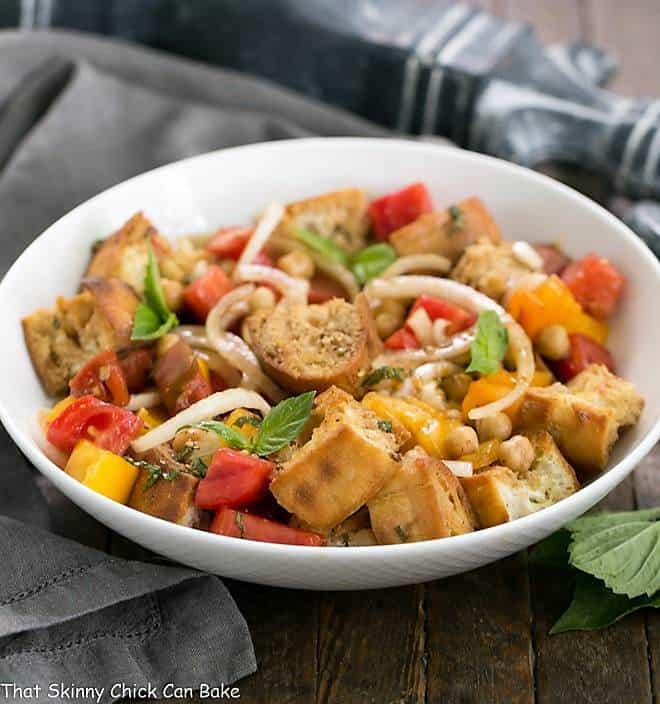 Summer Tomato and Burrata Panzanella Salad in a white ceramic serving bowl