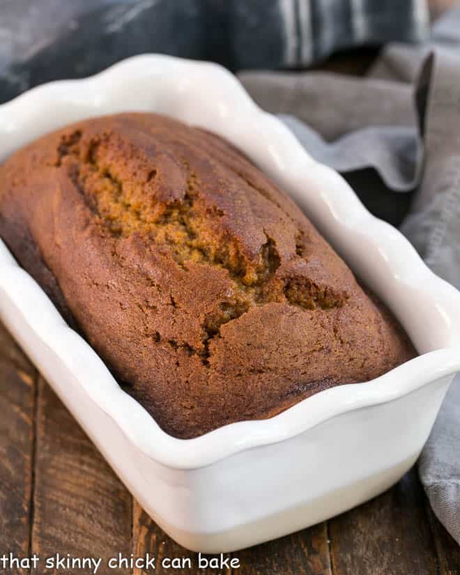 Classic Pumpkin Bread Recipe in a white ceramic baking dish.