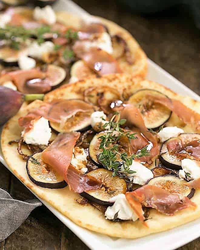 Fig, Goat Cheese and Prosciutto Pizza on a white tray.