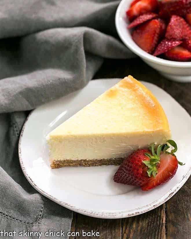 Perfect vanilla cheesecake with strawberries on a white plate