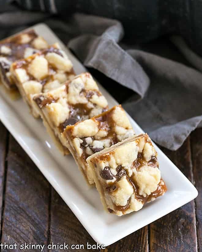 Chocolate Chip Caramel Butter Bars on a narrow white tray.