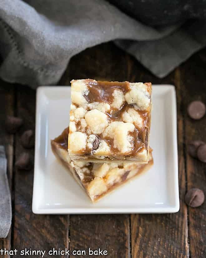Chocolate Chip Caramel Butter Bars on a square white ceramic plate.