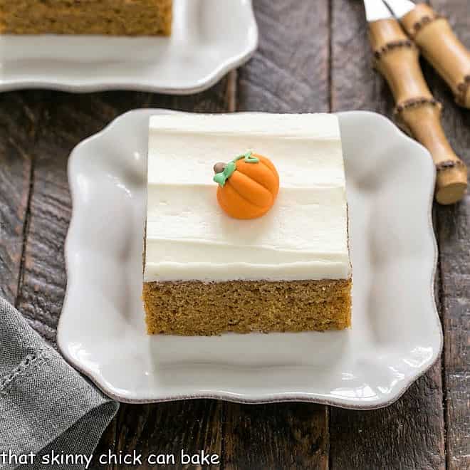 Pumpkin bar on a square wite plate with a couple bamboo forks