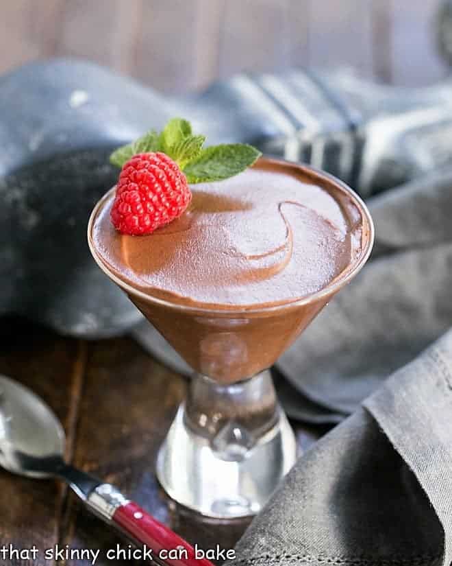 Chocolate Truffle Mousse AKA Mousse au Chocolat in a martini glass with a raspberry and mint.