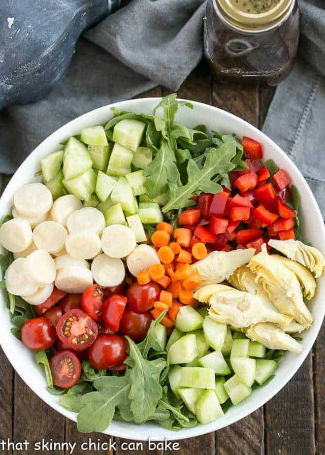 Easy Balsamic Vinaigrette next to a vegetable salad in a white bowl