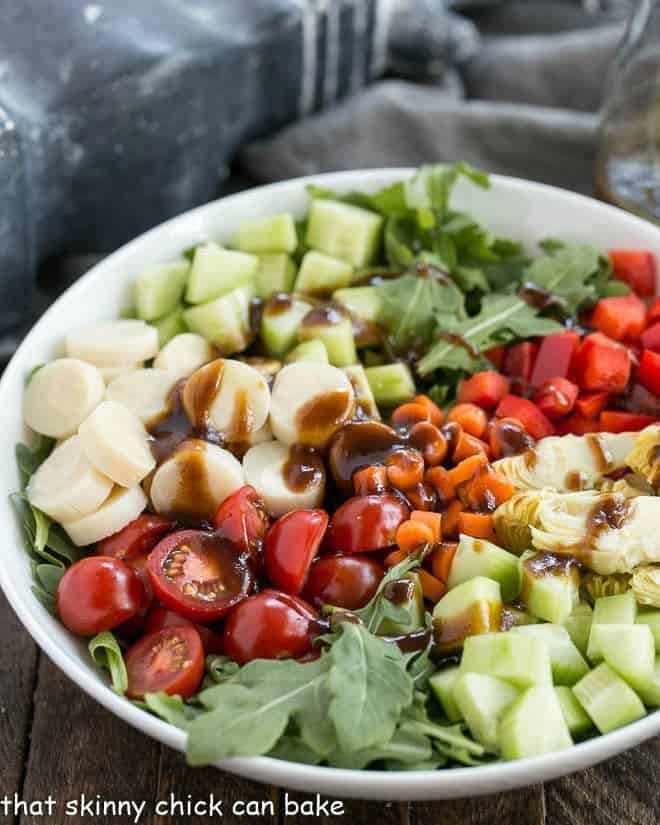 Easy Balsamic Vinaigrette on a vegetable salad in a white bowl