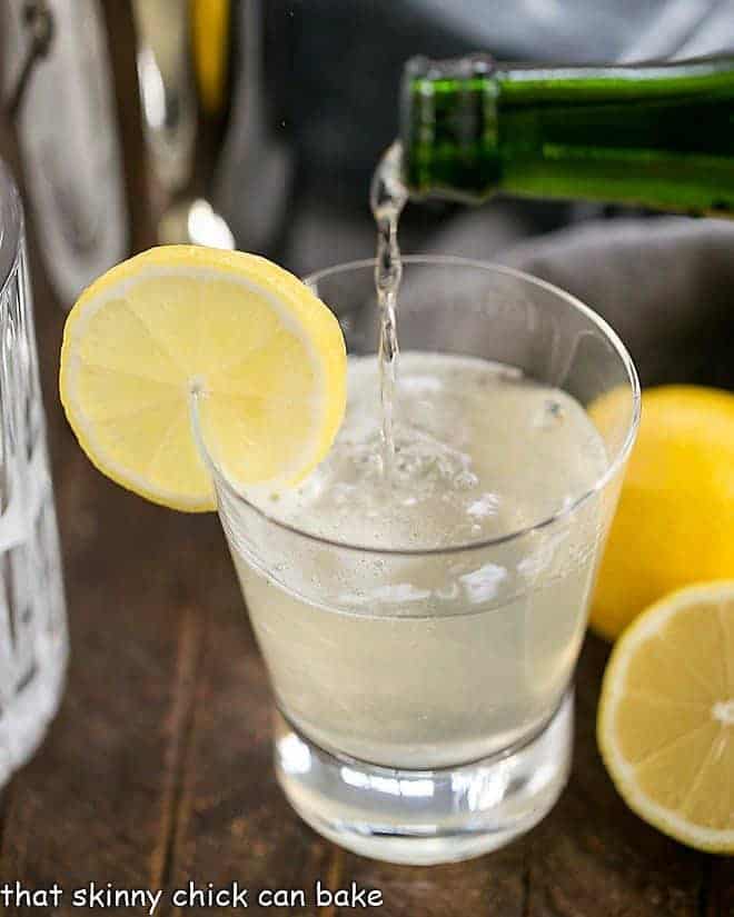 French 75 Champagne Cocktail garnished with a slice of lemon.