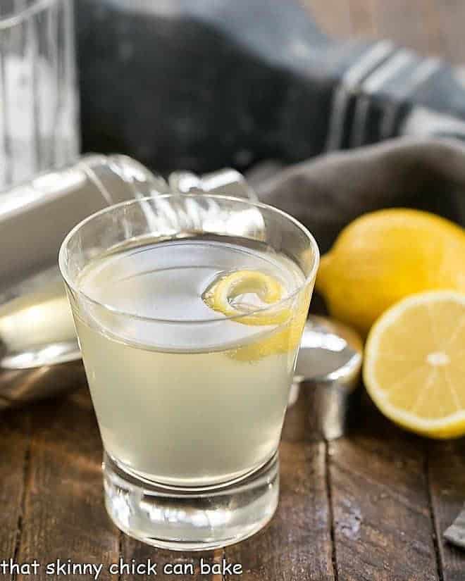 French 75 Champagne Cocktail with a lemon twist in a highball glass.