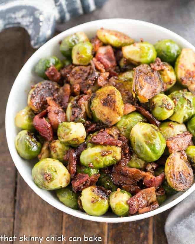 Maple Syrup Mustard Glazed Brussels Sprouts in a white serving bowl.