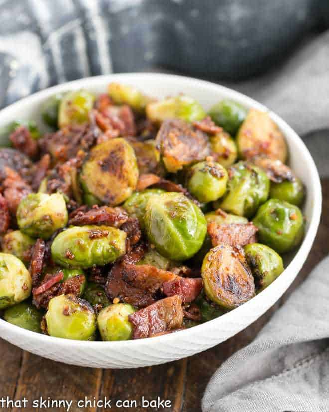 Maple Syrup Mustard Glazed Brussels Sprouts in a round white ceramic bowl