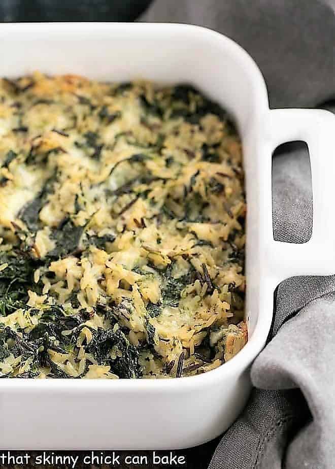 Cheesy Spinach Rice Casserole baked in a white baking dish