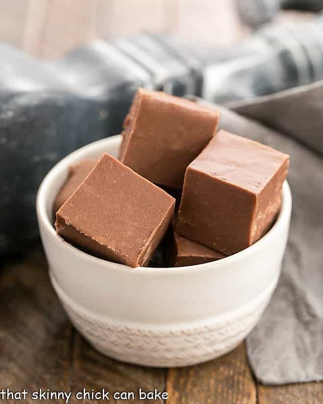Cubes of an Easy Fudge Recipe in a small white bowl