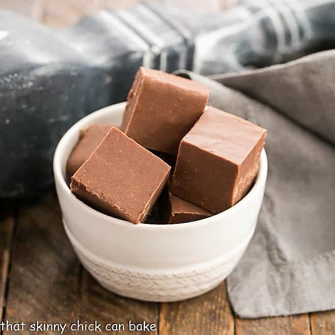 Easy fudge recipe squares in a white ceramic bowl.