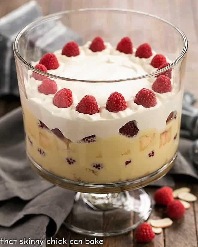 Traditional English Trifle topped with whipped cream and fresh raspberries.